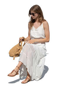 cut out woman in a white summer dress sitting