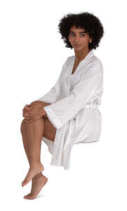 cut out woman in a silky white bathrobe sitting