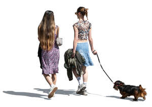 two cut out women with a dog walking