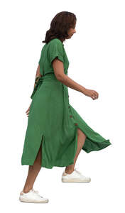 cut out woman in a green dress walking up the stairs