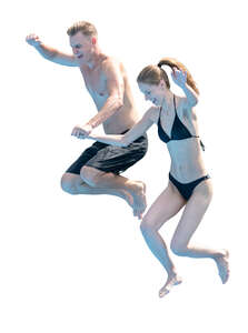 man and woman jumping into the pool together