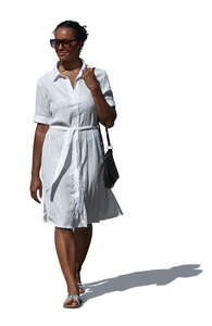 woman in a simple white summer dress walking