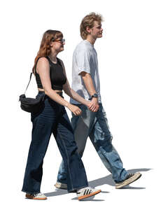 two young people walking and holding hands