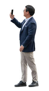 asian businessman taking photos with his phone