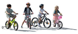 backlit group of little kids with bikes