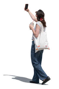 cut out woman walking in the street and taking pictures