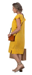 mature woman with a shopping bag walking
