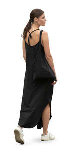 woman in a casual black summer dress walking