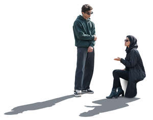 middle eastern woman sitting and talking to a young man