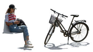 cut out woman sitting outside near her bike