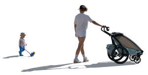 woman with a stroller and a child with a toy walking