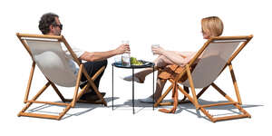man and woman sitting on outdoor chairs