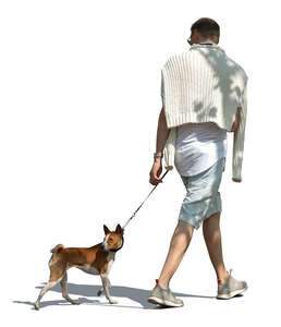 man walking a dog in tree shade