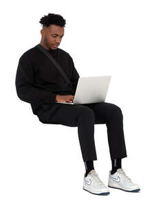 man sitting and working with a laptop