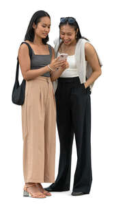 two asian women standing and looking at a phone together