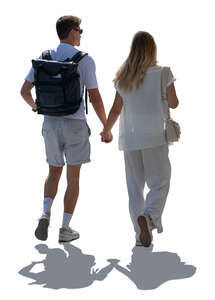 backlit man and woman walking in summer