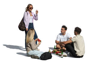 cut out group of friends having a picnic and eating a watermelon