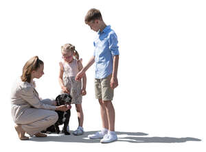 Three children petting a dog