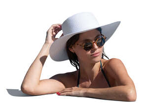 cut out woman with a hat leaning on the edge of the pool