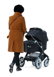 woman with a baby carriage walking in autumn