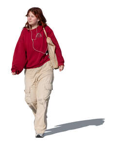 teenage girl walking and listening to music
