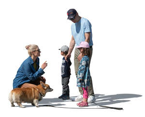 woman with a dog talking to her kids and husband