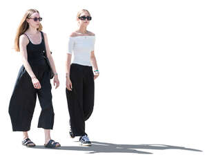 two cut out women walking in backlight