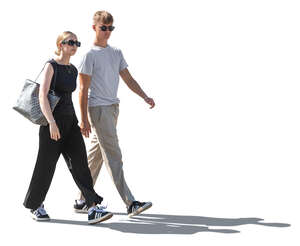 backlit man and woman walking