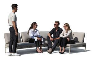 group of successful young people sitting on an outdoor patio sofa