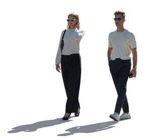 man and woman walking in backlight