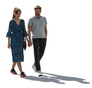 backlit couple walking hand in hand