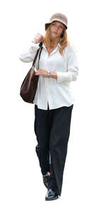 woman with a hat and wearing a white shirt walking