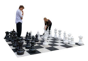 two people playing giant chess in the street