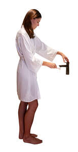 woman standing in the bathroom and brushing teeth