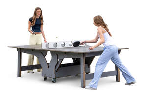 two teenage girls playing table tennis