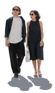 backlit man and woman walking side by side