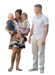 woman holding two children and her husband is standing by