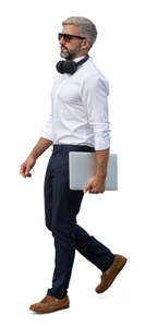 handsome businessman with a laptop walking