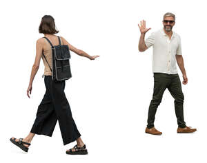man and woman greeting and waving to each other