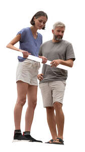 man and woman standing on a balcony and looking down