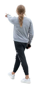 woman in joggers walking and pointing at smth