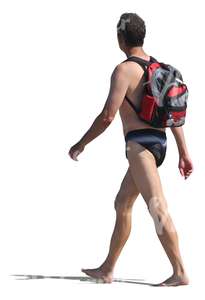 man in swimming pants walking barefoot