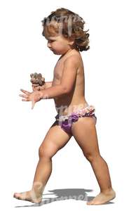 girl with an ice cream walking on the beach