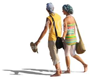 couple walking barefoot on the beach