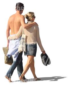 couple walking barefoot arm in arm