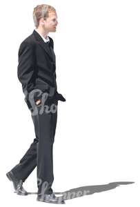 man in a black suit walking