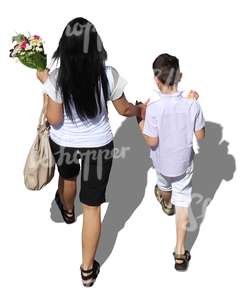 mother and son walking hand in hand