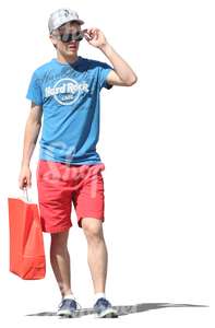 young man standing with a shopping bag in his hand