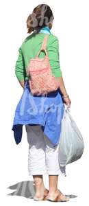 woman standing with a shopping bag in her hand