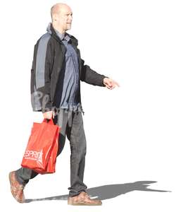 man walking with a bag in his hand